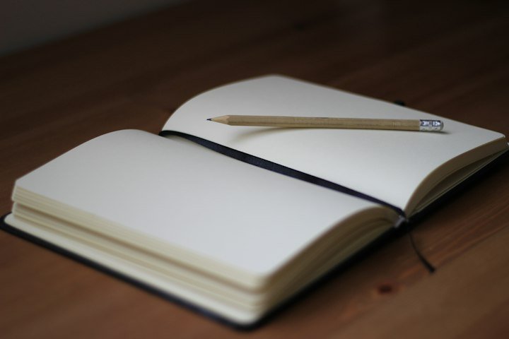 A pencil resting on an open notebook, an editorial scene for self-paced learning
